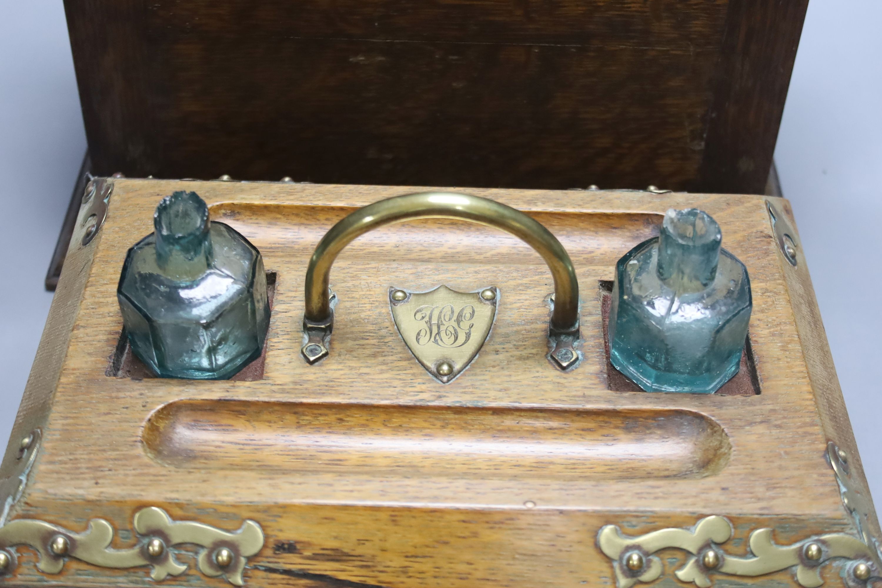 An Edwardian oak stationery box and an oak inkstand